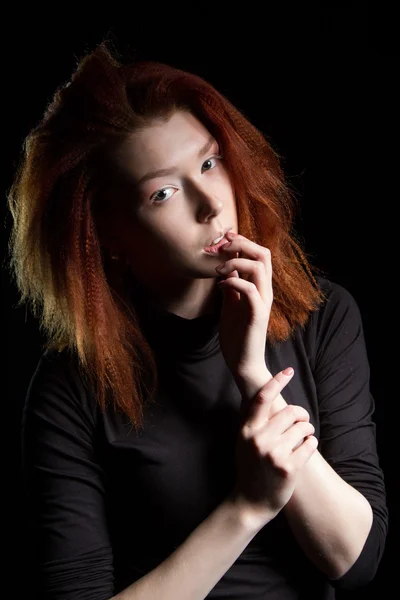 The girl with red hair on a black background — Stock Photo, Image