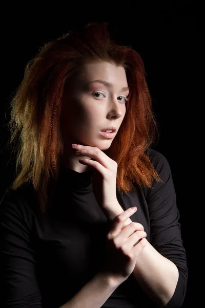 The girl with red hair on a black background — Stock Photo, Image