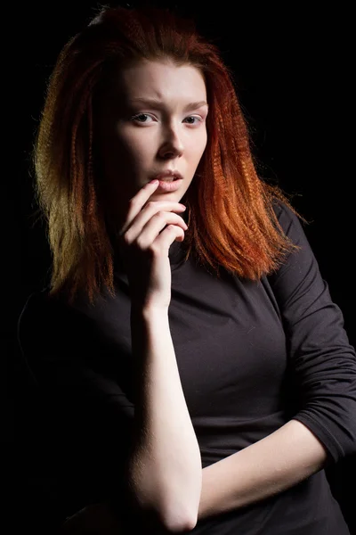 The girl with red hair on a black background — Stock Photo, Image