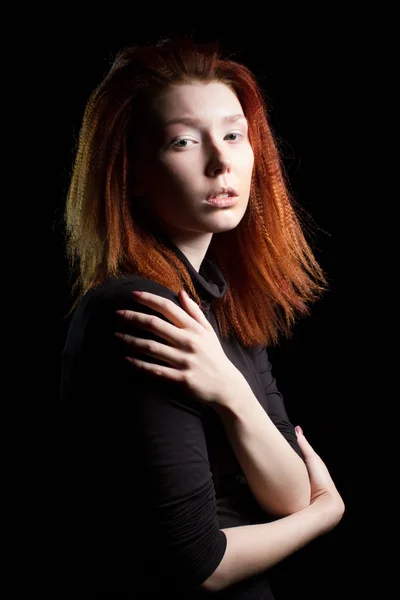 Girl with red hair on a black background — Stock Photo, Image