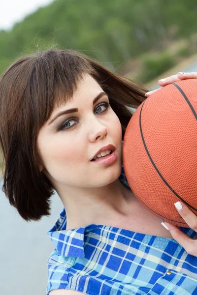 Pretty young girl holding a basketball — Stock Photo, Image