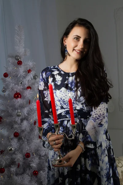 Young girl with candles at the Christmas tree — Stock Photo, Image