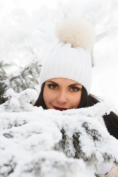 Girl in the woods among the snowy trees — Stock Photo, Image
