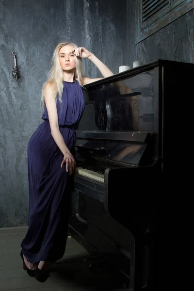 Blonda flickan i frack på pianot — Stockfoto