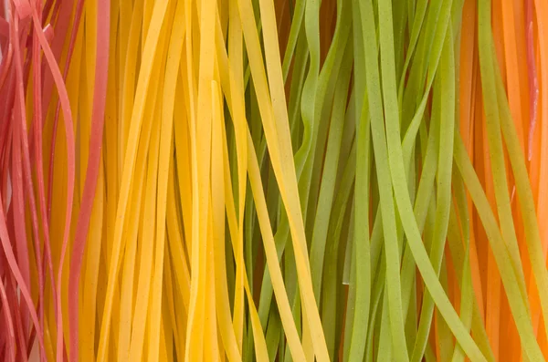 Multicolored raw noodles — Stock Photo, Image