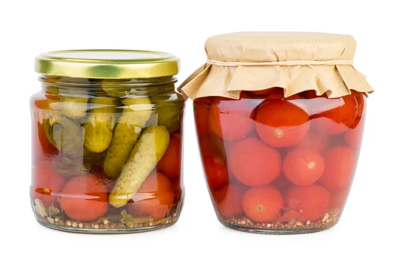 Glass jars with marinated tomatoes and cucumbers — Stock Photo, Image