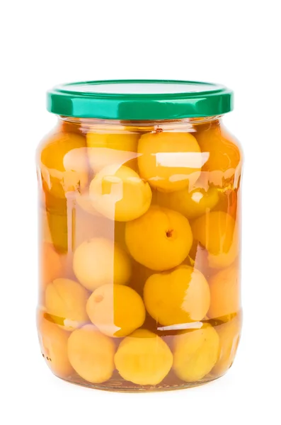 Glass jar with preserved apricots — Stock Photo, Image