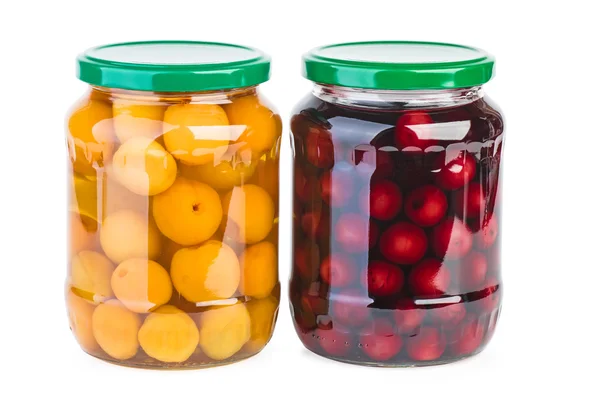 Glass jars with preserved cherries and apricots — Stock Photo, Image