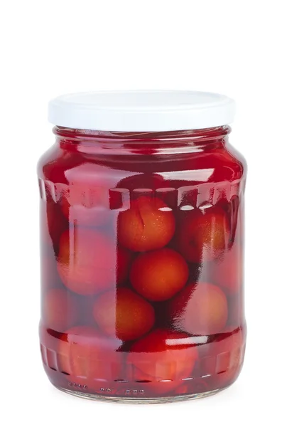 Glass jar with preserved plums — Stock Photo, Image