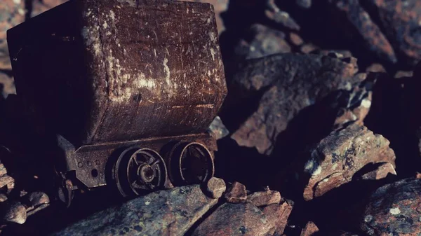 abandoned rusty mine cart on rocks
