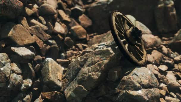 Old wooden wheel on rocks — Stock Footage Old wooden wheel on rocks Royalty Free Stock Footage