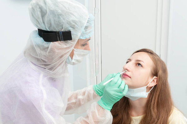 Coronavirus test. The doctor takes a nasal swab for coronavirus from the patient.Covid-19 pandemic