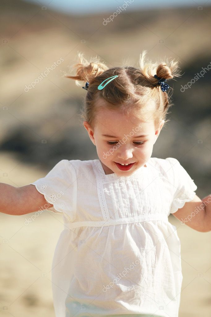 Little girl on sandy beach