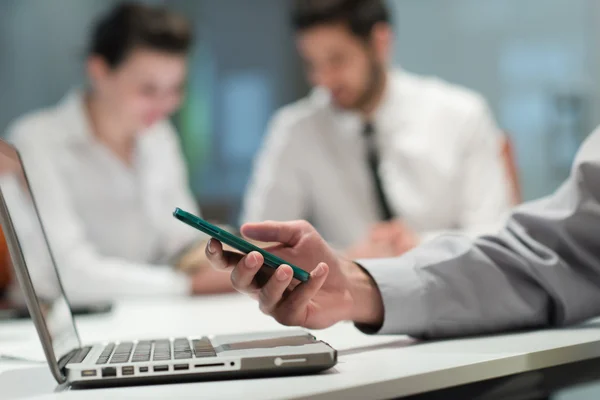 Close up of  businessman hands  using smart phone on meeting — Stock Photo, Image