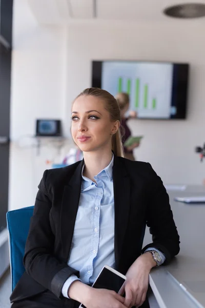 Portrait of young business woman at office with team on meeting — Stock Photo, Image