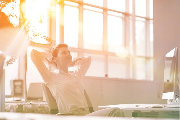 Young business woman relaxing at workplace — Stock Photo, Image