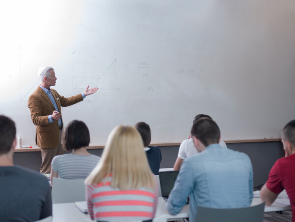 portrait of in teacher in classroom with students 
