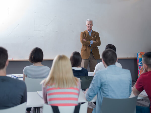portrait of in teacher in classroom with students 