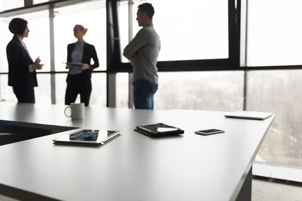 Close up of tablet, business people on meeting in background — Stock Photo, Image