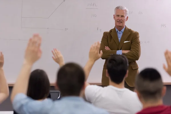 Teacher with a group of students in classroom — Stock Photo, Image