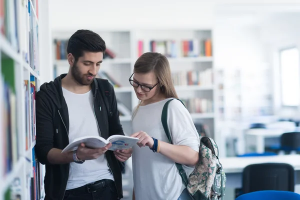 Estudantes casal na biblioteca da escola — Fotografia de Stock