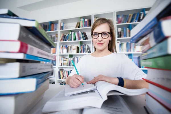 Estudante feminina na biblioteca — Fotografia de Stock