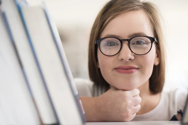 Female student selecting book to read in library — Stock Photo, Image