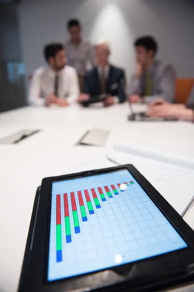 Close up of touchpad with analytics documents at business meetin — Stock Photo, Image