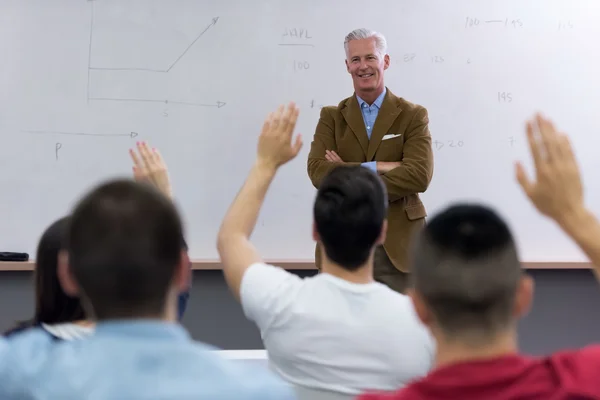 Teacher with a group of students in classroom — Stock Photo, Image