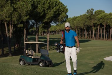 yürüyüş ve golf çantası taşıyan golfçü