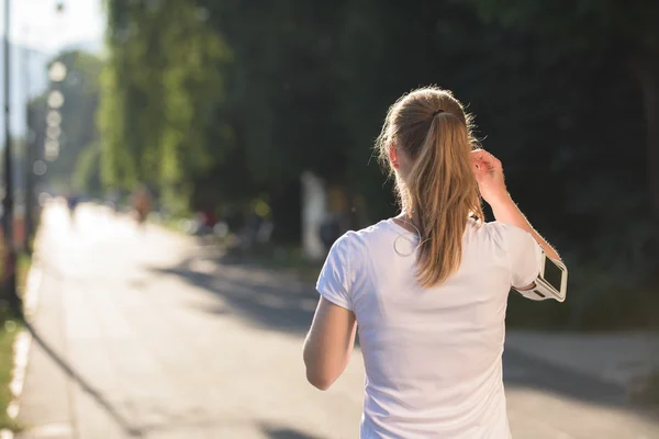 Jogging donna impostazione telefono prima di fare jogging — Foto Stock