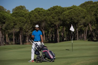 Tekerlekli çanta ile yürüyüş golf oyuncu