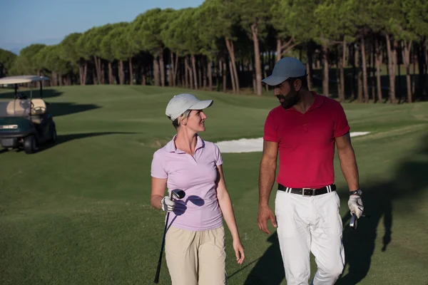 Couple walking on golf course — Stock Photo, Image