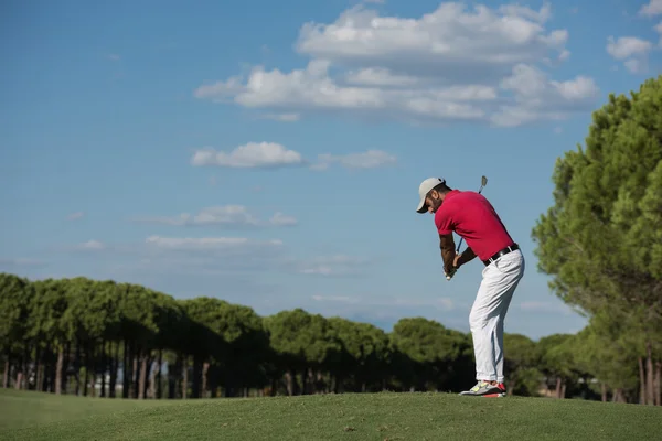 Golf player hitting long shot — стоковое фото