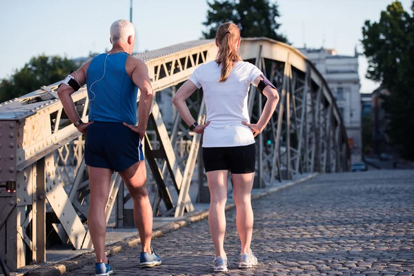 Jogging couple planning running route  and setting music — Stock Photo, Image