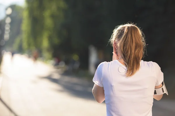 Jogging donna impostazione telefono prima di fare jogging — Foto Stock