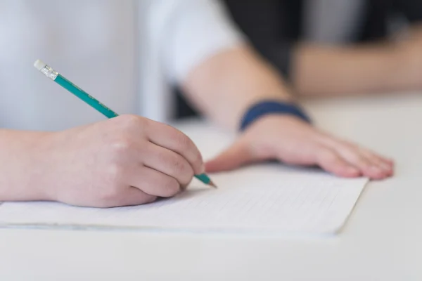 Manlig student anteckningar i klassrummet — Stockfoto