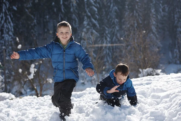 Kids playing with  fresh snow — Stock Photo, Image