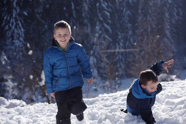 Kids playing with  fresh snow — Stock Photo, Image