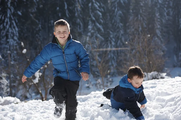 Kids playing with  fresh snow — Stock Photo, Image