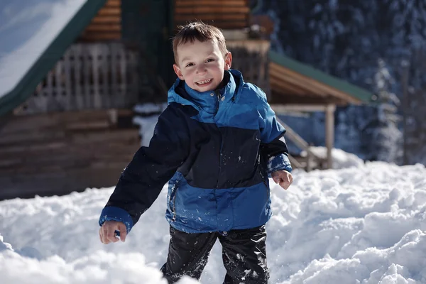 Kid playing with  fresh snow — Stock Photo, Image