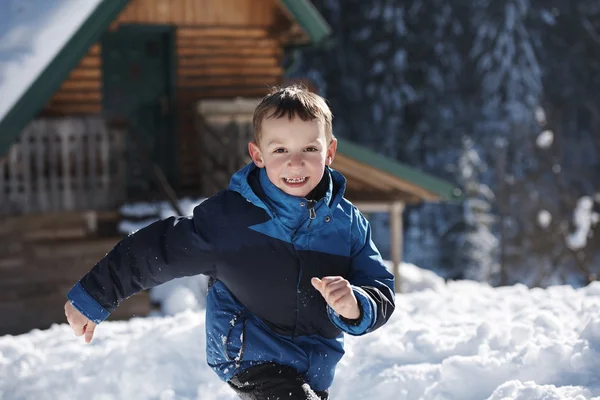 Kid playing with  fresh snow — Stock Photo, Image