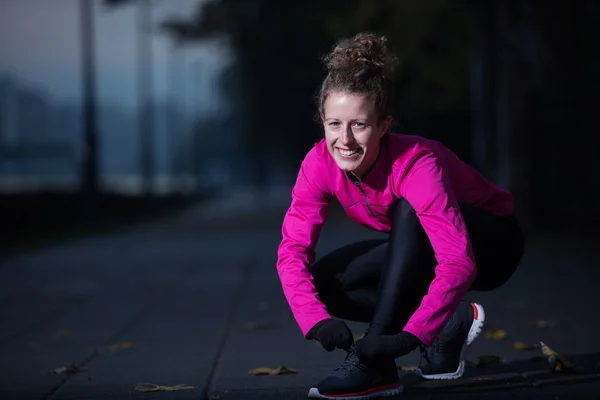 Vrouw die zich uitstrekt voordat ochtend joggen — Stockfoto