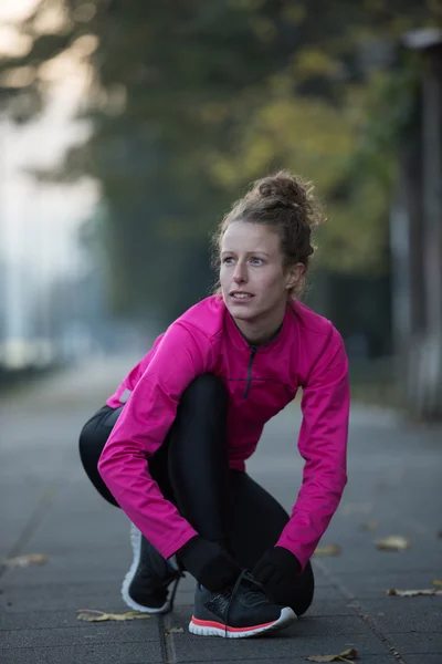 Kvinnan stretching innan morgon jogging — Stockfoto