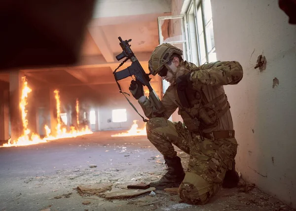 soldier in action near window changing magazine and take cover