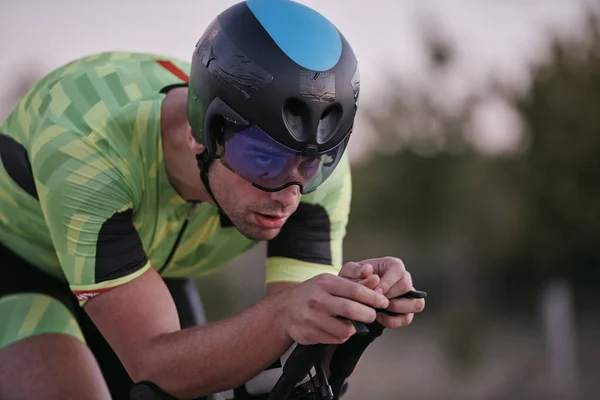 Triathlon athlete riding a bike — Stock Photo, Image