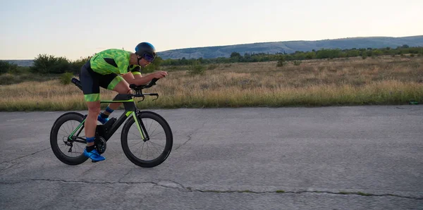 Triathlon athlete riding a bike — Stock Photo, Image