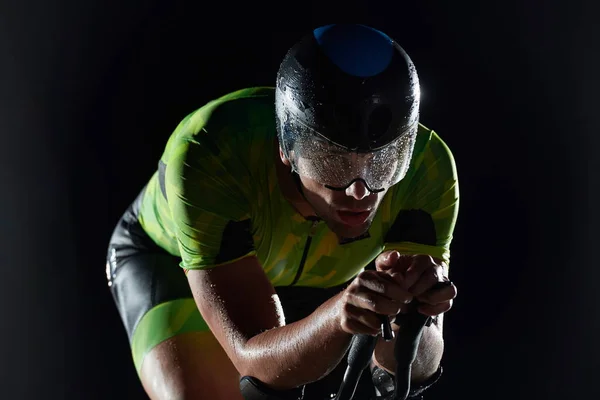 Триатлон атлет езда на велосипеде быстро ночью — стоковое фото