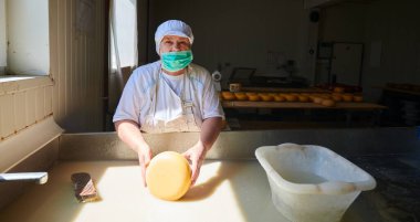 İşçiler peynir üretimi için çiğ süt hazırlıyorlar