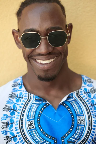 Retrato de un joven africano sonriente vestido con ropa tradicional —  Fotos de Stock